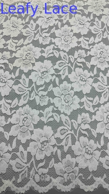 Full Width Stretch Lace Fabric In White, Adorned With Delicate Floral Patterns And Scalloped Edges Luxuriously