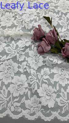 Full Width Stretch Lace Fabric In White, Adorned With Delicate Floral Patterns And Scalloped Edges Luxuriously